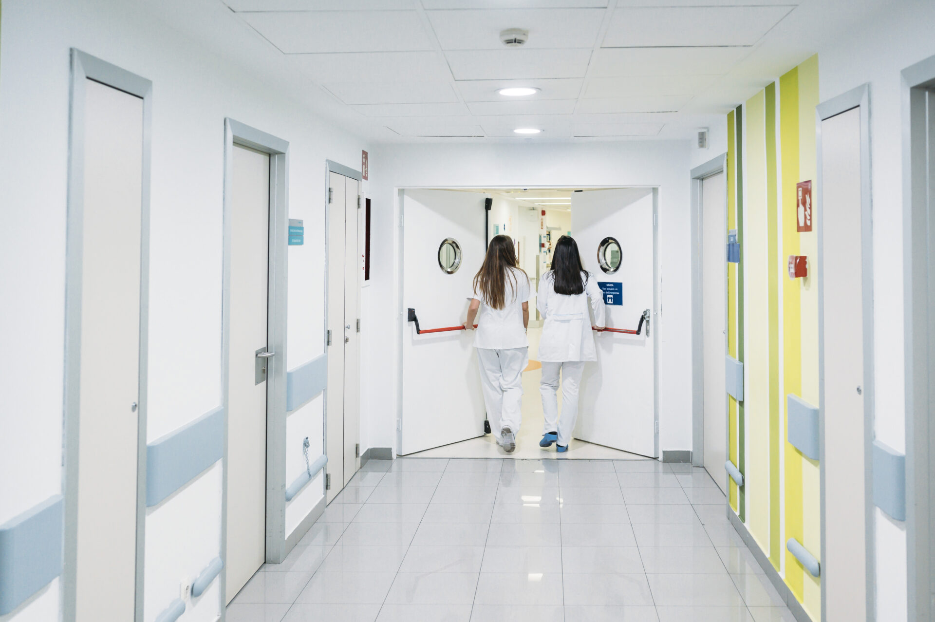 Doctors walking through set of doors